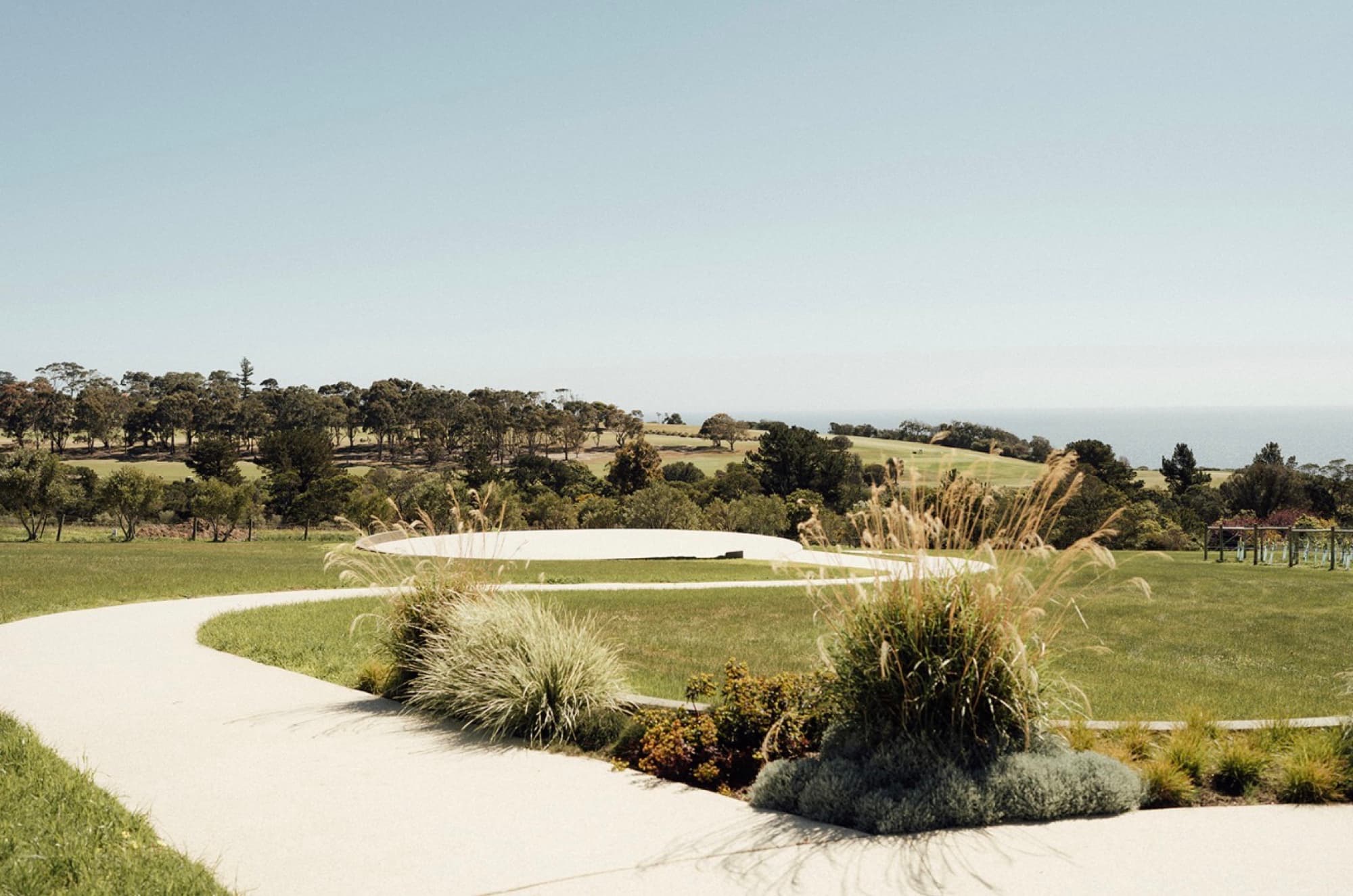 The winding path to the ceremony circle at Sunnyside Estate, Port Phillip Bay beyond
